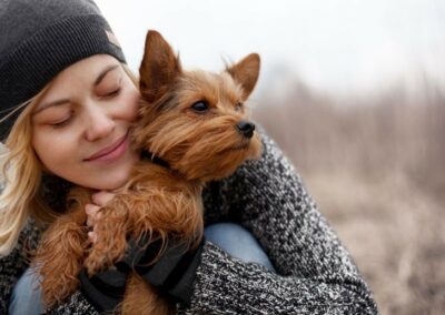 A woman giving a warm hug to her adorable dog.